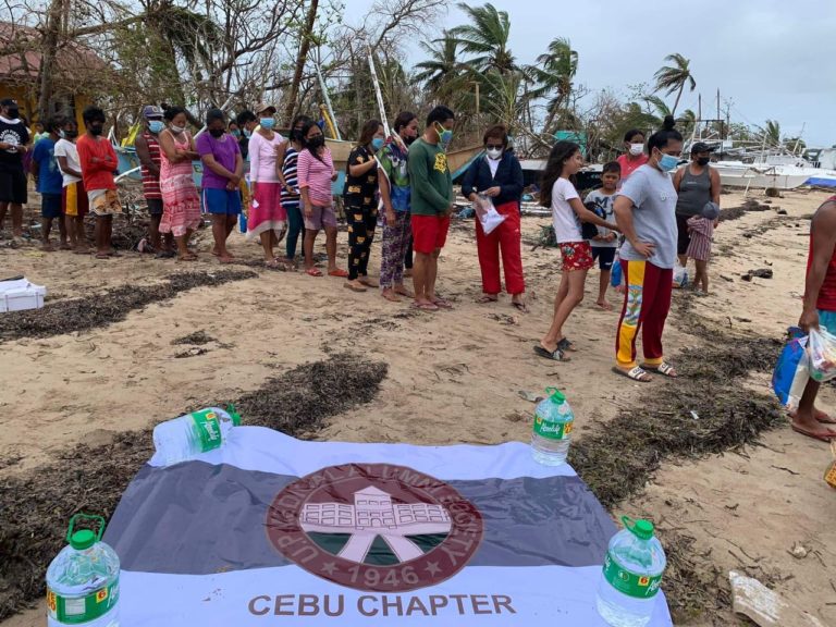 Residents of Caohagan Island queue up to receive their relief packs. Distribution and preparation of relief packs was done in partnership with UP Medical Alumni Society Cebu Chapter